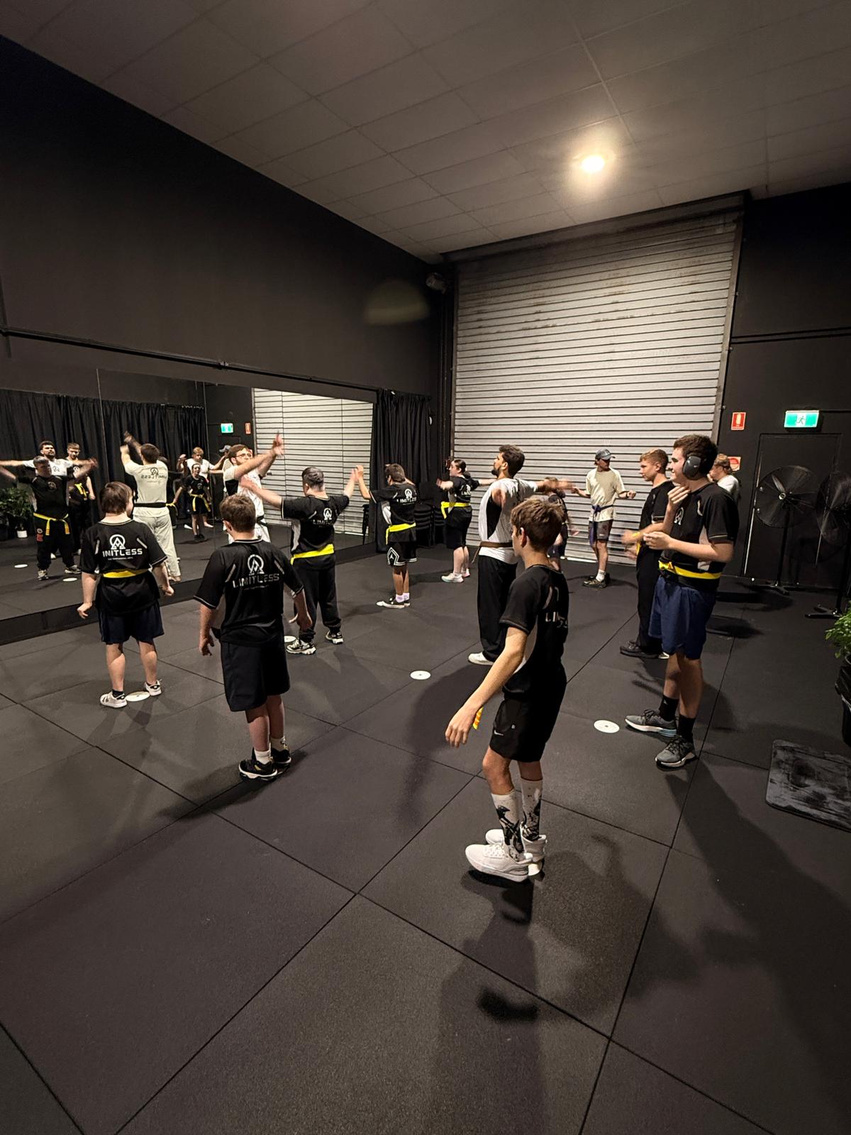 Limitless Impact students training together on the mats